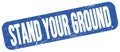 STAND YOUR GROUND text on blue grungy stamp sign