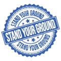 STAND YOUR GROUND text on blue round stamp sign