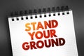 Stand Your Ground text on notepad, concept background