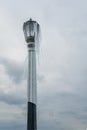 Standalone tall street lamp covered with icicles after a winter freezing storm with grey clouds as background Royalty Free Stock Photo