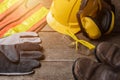 Standard construction safety equipment on wooden table Royalty Free Stock Photo