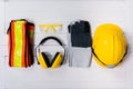 Standard construction safety equipment on wooden table. top view