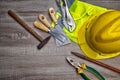 Standard construction safety equipment on wooden table. top view Royalty Free Stock Photo