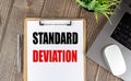 STANDARD DEVIATION text on clipboard paper with laptop, mouse and pen Royalty Free Stock Photo