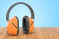 Standard Ear Defenders on the wooden planks, 3D rendering