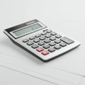 A standard electronic calculator rests on a clean, white surface. It features a digital Royalty Free Stock Photo