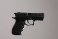 Standard handgun on light grey background. Semi-automatic pistol