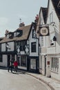 The Standard Inn 15th Century pub on The Mint street in Rye, UK, people walk on background