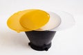 Standard reflector with matt white and yellow diffuser on a white background. Different diffusers for light temperatures. Royalty Free Stock Photo