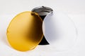 Standard reflector with matt white and yellow diffuser on a white background. Different diffusers for light temperatures. Royalty Free Stock Photo