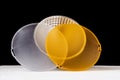 Standard reflector with matt white and yellow diffuser on a black background. Different diffusers for light temperatures. Royalty Free Stock Photo