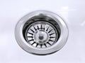 Standard round drain hole in white domestic sink