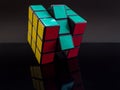 Standard traditional rubik`s cube on black background with reflection solved Royalty Free Stock Photo