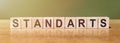 STANDARTS word written on wooden blocks on wooden table. Concept for your design