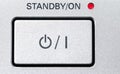 Standby-button in a gray with a grainy texture.