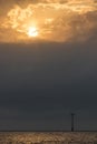 Standing against climate change. Solitary wind turbine at sunrise