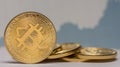 standing bitcoin next to each other with a fluctuating stock market chart in the background detail Royalty Free Stock Photo