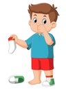 Standing boy kid holding dirty smelling sock in hand closing nose Royalty Free Stock Photo