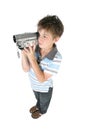 Standing boy using a digital video camera Royalty Free Stock Photo