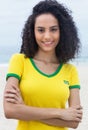 Standing brazilian sports fan with curly hair and crossed arms Royalty Free Stock Photo