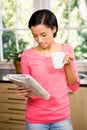 Standing brunette holding cup and newspaper Royalty Free Stock Photo