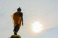 Standing Buddha image with sky