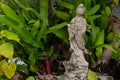 Standing Buddha Statue in a Lush Green Garden Royalty Free Stock Photo