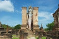 Standing Buddha statue at the ruins of the Wat Mahathat temple in Sukhothai Historical Park, Thailand. Royalty Free Stock Photo