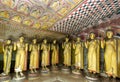 Standing Buddha statues inside Cave Three (Maha Alut Viharaya) at the Dambulla Cave Temples in central Sri Lanka.