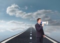 Standing businessman shouting through a megaphone Royalty Free Stock Photo