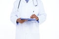 Standing doctor in white tunic writing notes