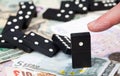 Standing dominoes on bank notes Royalty Free Stock Photo