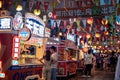 Standing at food booths waiting for their food in Xunlimen Food Street in Wuhan city at night, China