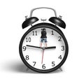 Standing on hands of alarm clock Royalty Free Stock Photo