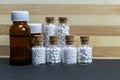 Standing homeopath medicine bottles in a row on wood and dark background Royalty Free Stock Photo