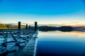 Standing on the jetty enjoying mountain and sky reflections on the calm surface of the West Coasts Lake Ianthe Royalty Free Stock Photo