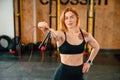 Standing with jump rope. Beautiful strong woman is in the gym Royalty Free Stock Photo