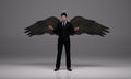 3D rendering : a standing man with a pair of wings at his back pose in black business suit Royalty Free Stock Photo