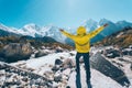 Man with raised up arms near the river against mountains Royalty Free Stock Photo