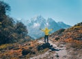 Standing man on the stone against snowy mountains Royalty Free Stock Photo