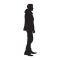 Standing man in winter jacket, isolated vector silhouette. Side view Royalty Free Stock Photo