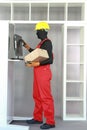 Standing manual worker dealing with box in distribution center. Royalty Free Stock Photo