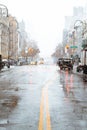 Standing in the middle of a wet snow covered city street