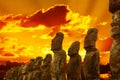 Standing moais at Ahu Tongariki in Easter Island at dramatic gloden sunset