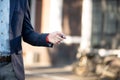 Businessman standing near building and unlocking his car