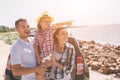 Young couple standing near the opened car boot with suitcases and bags. Dad, mom and daughter are traveling by the sea Royalty Free Stock Photo