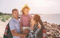 Young couple standing near the opened car boot with suitcases and bags. Dad, mom and daughter are traveling by the sea Royalty Free Stock Photo