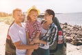 Young couple standing near the opened car boot with suitcases and bags. Dad, mom and daughter are traveling by the sea Royalty Free Stock Photo