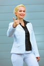 Standing at office business woman showing thumb up Royalty Free Stock Photo