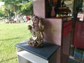 A standing old porcelain Buddha statue of Budai at the corridor entrance of the home